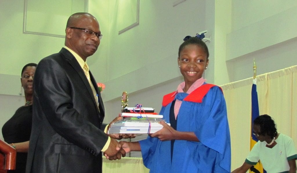 Top girl in the Barbados Secondary Schools' Entrance Examination, Azaria Johnson presented with some of her prizes by Anthony Gittens. (GP)