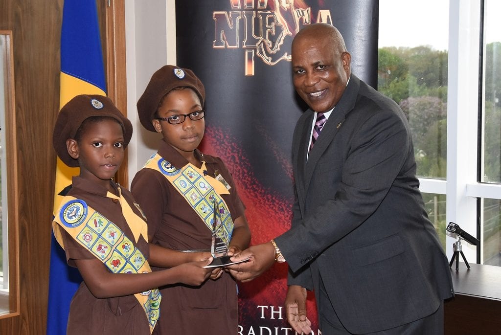 Lawrence T. Gay students Nyasha Waltress (left) and Tai Archer receiving their culinary arts award from Environment Minister, Dr. Denis Lowe. (C.Pitt/BGIS)