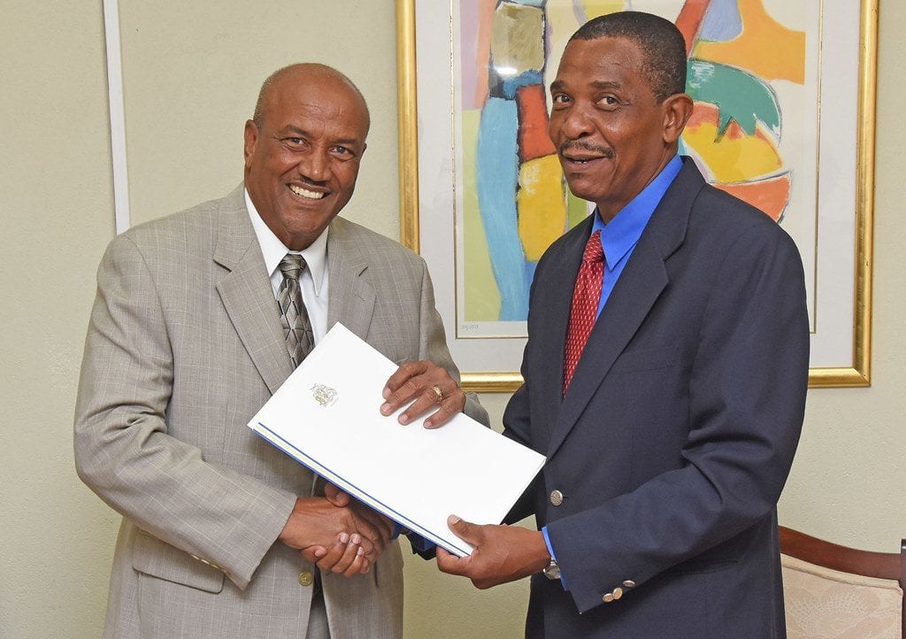 Chief of Protocol, Philip St. Hill (right) presenting the Exequatur and Commission of Appointment to South Korea's new Honorary Consul in Barbados, Roland Bullen. (C.Pitt/BGIS)