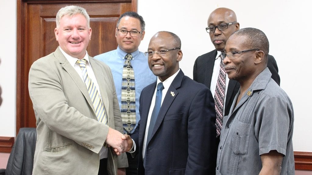 Sports Minister, Stephen Lashley shaking hands with EMERA's Vice President of Asset Management, David McGregor while (l-r) EMERA's Senior Business Development Officer, Roger Blackman; Interim CEO of Gymnasium Ltd, Jerry Blenman; and Housing Minister, Denis Kellman look on. (J.Weekes/BGIS)