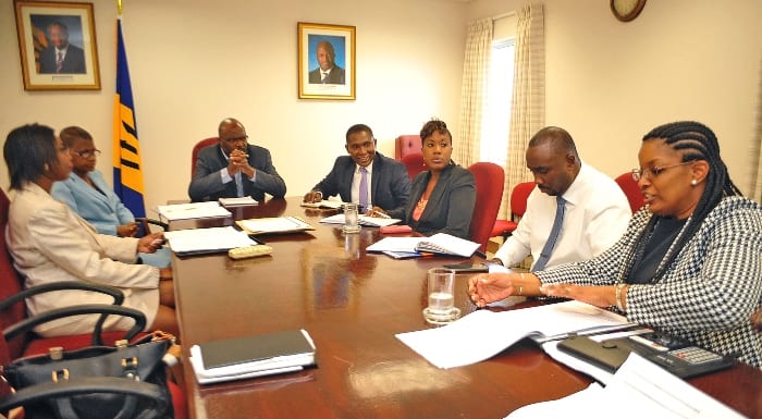 Attorney General, Adriel Brathwaite (head of table) and Barbados' Ambassador to the United States, Selwin Hart (to the Minister's left) listening to Manager of the National Council on Substance Abuse, Betty Hunte during a recent meeting at his Wildey, St. Michael. (A.Miller/BGIS