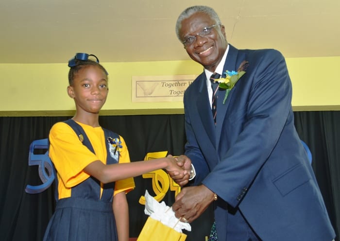 Prime Minister Freundel Stuart receiving a gift from head girl of St. Bartholomew’s Primary, Janae Jordan-White during a visit to the school today. Mr. Stuart addressed students on the topic 'A day in the life of a Prime Minister'. (B.Hinds/BGIS)
