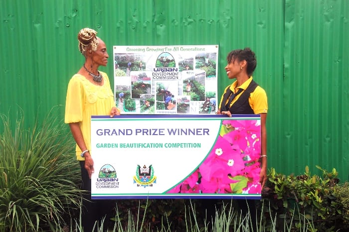 UDC Project Officer, Paula Gall (right) making a presentation to winner of the Commission’s 2016 Garden Beautification Competition, Marcia Springer today. (C.Henry/BGIS)